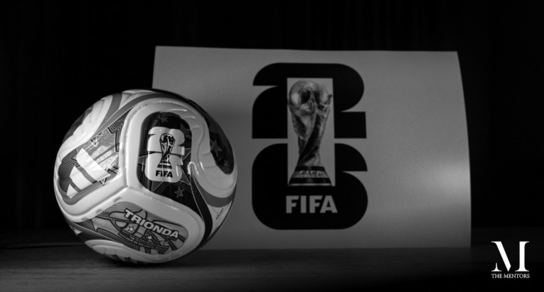 Black-and-white image of a FIFA World Cup football beside the FIFA World Cup 2026 logo and trophy, illustrating Toby Cadman’s article “Justice Suspended” on governance, institutional integrity and trust in football.