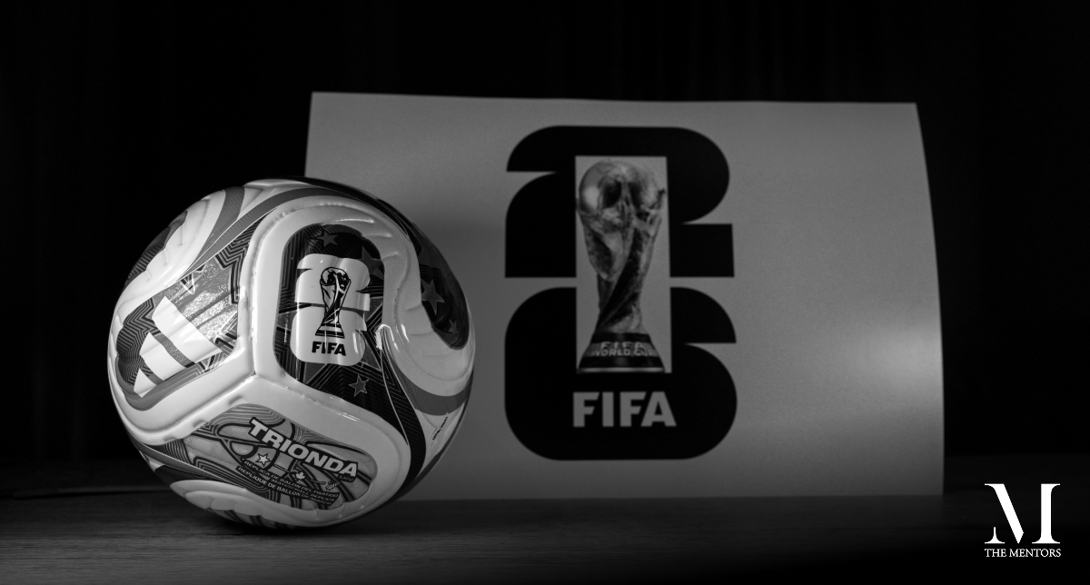 Black-and-white image of a FIFA World Cup football beside the FIFA World Cup 2026 logo and trophy, illustrating Toby Cadman’s article “Justice Suspended” on governance, institutional integrity and trust in football.